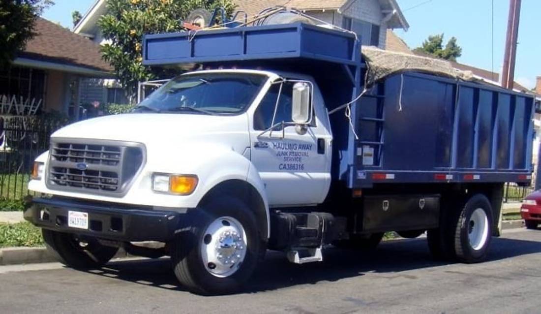 Hauling Away blue junk removal truck on a Los Angeles street